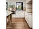Bright kitchen with marble countertops, white cabinets, and stainless steel appliances at 9733 E Clinton St, Scottsdale, AZ 85260