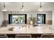 Modern kitchen with a large island, stylish lighting, and seamless indoor-outdoor flow at 9733 E Clinton St, Scottsdale, AZ 85260