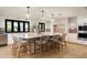 Bright kitchen boasts a large island with seating and modern appliances at 9733 E Clinton St, Scottsdale, AZ 85260