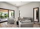 Cozy living room with stylish seating, a modern rug, and sliding glass doors to the patio at 9733 E Clinton St, Scottsdale, AZ 85260