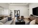 Inviting living room with a large sectional, stylish armchairs, and a contemporary design at 9733 E Clinton St, Scottsdale, AZ 85260