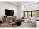 Well-lit living space features modern furnishings, a large sectional sofa, and an entertainment center at 9733 E Clinton St, Scottsdale, AZ 85260
