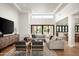 Bright, open-concept living room with contemporary furnishings, hardwood floors, and seamless indoor-outdoor flow at 9733 E Clinton St, Scottsdale, AZ 85260
