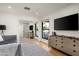 Contemporary living room with a TV, dresser, mirror closet, and outdoor view at 9733 E Clinton St, Scottsdale, AZ 85260