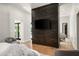 Comfortable main bedroom featuring a dark wood accent wall and a ceiling speaker at 9733 E Clinton St, Scottsdale, AZ 85260