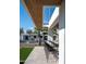 Outdoor bar area with sleek black stools, overlooking the pool, sports court, and lush backyard at 9733 E Clinton St, Scottsdale, AZ 85260