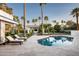 Backyard with luxurious pool, covered lounge area, and palm trees at 9733 E Clinton St, Scottsdale, AZ 85260