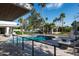 Inviting backyard with pool, outdoor kitchen, pergola, and lush landscaping at 9733 E Clinton St, Scottsdale, AZ 85260