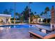 Inviting backyard pool and spa with surrounding lounge chairs and a modern outdoor pergola at 9733 E Clinton St, Scottsdale, AZ 85260