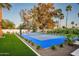 Nicely landscaped backyard featuring a sports court outlined with manicured shrubs and gravel at 9733 E Clinton St, Scottsdale, AZ 85260