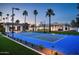 A sports court with palm trees lining the perimeter, conveniently located near the house and lounge area at 9733 E Clinton St, Scottsdale, AZ 85260
