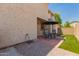 Exterior view of a backyard with a patio set, artificial grass and a stucco wall at 10055 E Isabella Ave, Mesa, AZ 85209