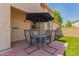 Inviting backyard patio with dining set and artificial grass, great for outdoor entertaining at 10055 E Isabella Ave, Mesa, AZ 85209