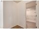 Bright bathroom with tile floors, and a view into a closet with installed shelving at 10055 E Isabella Ave, Mesa, AZ 85209