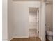 Bright and airy bathroom reveals a view to a closet with installed shelving at 10055 E Isabella Ave, Mesa, AZ 85209