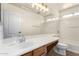 Bright bathroom featuring a large mirror, vanity, and shower-tub combo at 10055 E Isabella Ave, Mesa, AZ 85209
