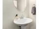 Bathroom featuring a modern pedestal sink, oval mirror and fresh white paint at 10055 E Isabella Ave, Mesa, AZ 85209