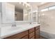 Bathroom featuring a double sink vanity and a shower-tub combination at 10055 E Isabella Ave, Mesa, AZ 85209