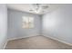 Cozy bedroom with a ceiling fan, a window, and neutral carpet flooring at 10055 E Isabella Ave, Mesa, AZ 85209