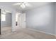 Neutral bedroom with a ceiling fan, mirrored closet, and view into the Primary bathroom at 10055 E Isabella Ave, Mesa, AZ 85209