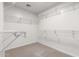 Walk-in closet featuring metal shelving for ample storage space and neutral carpet at 10055 E Isabella Ave, Mesa, AZ 85209