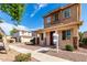 Charming two-story home featuring a cozy front porch and manicured landscaping at 10055 E Isabella Ave, Mesa, AZ 85209