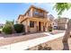 Charming two-story home featuring a cozy front porch and manicured landscaping at 10055 E Isabella Ave, Mesa, AZ 85209