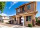 Charming two-story home featuring a cozy front porch and manicured landscaping at 10055 E Isabella Ave, Mesa, AZ 85209