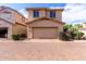 View of the exterior of a stucco house with a two-car garage and brick driveway at 10055 E Isabella Ave, Mesa, AZ 85209