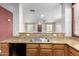 Kitchen showcasing a double sink and granite countertops, with an open view into the living area at 10055 E Isabella Ave, Mesa, AZ 85209