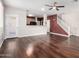 Spacious living room featuring wood floors, access to the kitchen, and a stairway leading to the upper level at 10055 E Isabella Ave, Mesa, AZ 85209