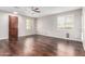 Bright living room featuring wood floors, neutral walls, and multiple windows for ample natural light at 10055 E Isabella Ave, Mesa, AZ 85209