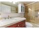 Updated bathroom featuring a granite vanity, decorative backsplash and glass enclosed shower at 10330 W Thunderbird W Blvd # B103, Sun City, AZ 85351