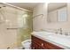 Bathroom featuring a walk-in shower, granite countertop, and vanity at 10330 W Thunderbird W Blvd # B103, Sun City, AZ 85351