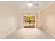 Bright bedroom with a ceiling fan and sliding glass doors leading to a private outdoor view at 10330 W Thunderbird W Blvd # B103, Sun City, AZ 85351