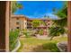 Captured through an archway, this is a lovely common area with gazebo, colorful flowers, and red tile roof at 10330 W Thunderbird W Blvd # B103, Sun City, AZ 85351