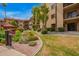 Beautifully landscaped community area with lush flower beds, mature trees and red gazebo at 10330 W Thunderbird W Blvd # B103, Sun City, AZ 85351