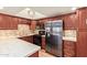 Modern kitchen with stainless steel appliances, granite countertops, and wood cabinets at 10330 W Thunderbird W Blvd # B103, Sun City, AZ 85351