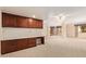 Spacious, well-lit living room with plush carpeting, built-in desk, and a ceiling fan at 10330 W Thunderbird W Blvd # B103, Sun City, AZ 85351