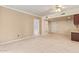 Bright living room with neutral walls and carpeting, crown molding, ceiling fan, and views of multiple doorways at 10330 W Thunderbird W Blvd # B103, Sun City, AZ 85351