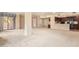 Open-concept living room featuring neutral carpeting, a ceiling fan, kitchen with granite countertops, and outdoor access at 10330 W Thunderbird W Blvd # B103, Sun City, AZ 85351