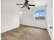 Cozy bedroom offers neutral carpet, a ceiling fan, and a window with a view at 1078 E Poncho Ln, San Tan Valley, AZ 85143