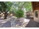 Picturesque backyard featuring flagstone paths winding through lush desert landscaping at 11034 W Sierra Pinta Dr, Peoria, AZ 85373