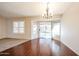 Bright dining area showcases elegant light fixture, sliding glass doors, and stylish shutters at 11034 W Sierra Pinta Dr, Peoria, AZ 85373