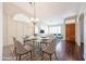 Bright dining area featuring a glass table, stylish chandelier, and modern decor at 11034 W Sierra Pinta Dr, Peoria, AZ 85373