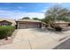 Attractive one-story home showcasing a three-car garage and landscaped front yard at 11034 W Sierra Pinta Dr, Peoria, AZ 85373