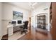 Well-lit home office features wood floors, shelving, and a comfortable workspace at 11034 W Sierra Pinta Dr, Peoria, AZ 85373