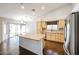 Bright kitchen showcasing a central island, granite countertops, and natural wood cabinets at 11034 W Sierra Pinta Dr, Peoria, AZ 85373