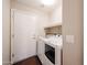 Functional laundry room with a full-size washer and dryer, storage shelf, and access to the exterior at 11034 W Sierra Pinta Dr, Peoria, AZ 85373