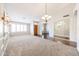 Spacious living room with plush carpeting, elegant chandelier and high ceilings at 11034 W Sierra Pinta Dr, Peoria, AZ 85373